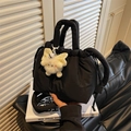 Black quilted puffer bucket bag with drawstring closure and cute plush monster charm - Black with Pendant