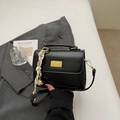 Elegant black faux leather crossbody bag with golden hardware and decorative silk scarf - Black