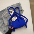 Bright blue quilted bucket bag with drawstring closure and plush pendant charm - Blue with Charm