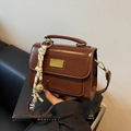 Dark brown faux leather crossbody square bag with gold hardware and woven rope charm - Brown