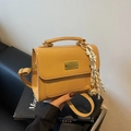 Chic mustard yellow leather shoulder bag with a crossbody strap and tassel detail - Khaki