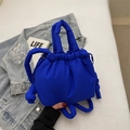 Fashionable royal blue puffer bucket bag with drawstring closure and knotted tube detail - Blue Without Charm
