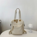 Mochila de nailon blanco crema con detalles de cuero marrón y correas laterales - Blanco Roto Sin Colgante