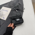 Quilted black crossbody bag with silver chain strap and metal adjustment ball detail - Black Small
