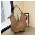 Close-up of khaki hobo bag with knotted strap detail on a minimalist metal table - Khaki