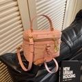 Pink vanity bucket bag with embossed floral patterns and golden hardware on leather - Pink