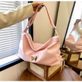 Pink oversized faux leather shoulder bag with a silver butterfly accent and side drawstring - Pink