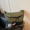 Army green nylon dumpling bag with adjustable wide strap and double zipper closure - Green