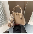 Close-up of beige leather bowling bag with cute teddy bear charm and double handles - Khaki with Pendant