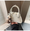 Detail of white leather bowling bag with twin handles and cute brown teddy bear charm - White with Pendant