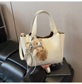 Detail of cream white PU leather bucket bag with logo embossing and cute bear charm - With Pendant / Apricot