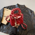 Mini red quilted crossbody bag with silk scarf handle and elegant pearl charm detail - Burgundy