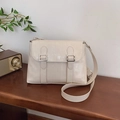 Chic cream-colored crossbody bag with faux leather texture and silver buckles - Off-white