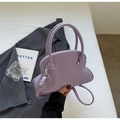 Detail of lavender shell bag with glossy finish, silver hardware, and slim shoulder strap - Purple