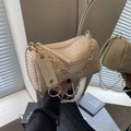 Beige woven straw cylinder bag with gold chain strap and textured fabric detail - Off White