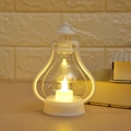 Close-up of white LED vintage lantern with candle light effect and desktop decor details - White