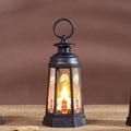 Macro shot of Halloween pumpkin lantern with wizard hat print and warm LED candle light - Pumpkin