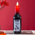 Detail of red wine bottle shaped LED electronic candle with elegant wine label design - Swing Wick Style