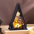 Macro detail of Halloween LED paper-cut lamp featuring a witch, pumpkin, and spooky scene - Witch