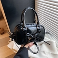 Glossy black Boston bag with ribbon bow and corset lacing detail for a chic vintage look - Black