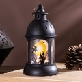 Detail van retro Halloween lantaarn met warm LED-licht en spookachtig kasteel silhouet - Heks
