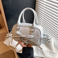 Light blue faux leather bow Boston bag with shoulder strap in a stylish hand-held pose - Grey Blue