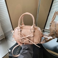 Elegant apricot pink Boston bag with ribbon bow and gathered side details for women - Pink