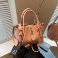 Pink lychee grain leather bucket bag with top handles and adjustable shoulder strap - Pink with Pendant