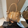 Chic beige bucket bag in lychee texture leather with gold hardware lock and strap - Khaki with Pendant