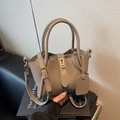 Elephant gray bucket bag in pebbled leather with gold twist lock and crossbody strap - Gray With Pendant