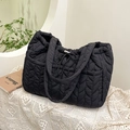 Minimalist black quilted tote bag with bubble texture and ribbon drawstring accents - Black