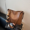Vintage caramel brown bucket bag in matte finish with a cute plush rabbit charm - Brown with Pendant