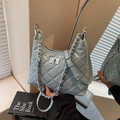 Quilted light blue crescent bag with silver chain strap and metallic swivel lock - Blue