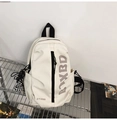 Close-up of cream crossbody bag with black straps and a checkerboard charm detail - White with Pendant