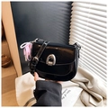 Detail of glossy black patent leather saddle bag with silver buckle and pearl pendant - With Charm / Black