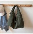 Detail of army green nylon hobo bag featuring drawstring accents and wrinkled texture - Green