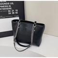 Detail of black PU leather tote with silver chain straps and rivet accents - Black