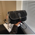 Detail of black pleated crossbody bag featuring a silver tennis racket charm and strap - With Pendant / Black