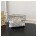 Close-up of blue and gold woven makeup bag with metal zipper on a dark wood desk - Blue Gold Marble Texture (Style 4)