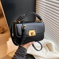 Classic black crossbody bag with a chunky woven handle and gold buckle closure - Black