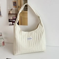 Minimalist beige pleated tote bag with wide shoulder strap and woven logo patch - White