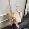 Creamy white lychee grain bucket bag with a cute plush bear charm and thin shoulder strap - White with Pendant