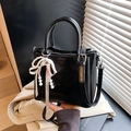 Glossy black bucket bag with pearl ribbon charm and detachable shoulder strap - With Charm / Black