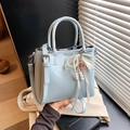 Light blue bucket bag in shiny synthetic leather with pearl ribbon and character pendant - With Charm / Blue
