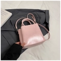 Light pink PU leather bucket bag with top handles and adjustable strap on dark suit - No Pendant / Pink