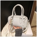 Detail of light grey leather boston bag with woven rope charms and top handle - Gray With Pendant