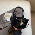 Sleek black bucket bag with silver heart charm and adjustable shoulder strap - Black with Pendant
