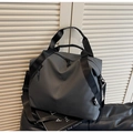 Detail of grey travel tote bag showing water-resistant fabric and adjustable shoulder strap - Gray