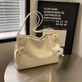 Minimalist beige pleated shoulder bag with plush monster charm and embossed lettering - Cream White With Pendant