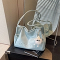 Light blue faux leather shoulder bag with embossed letters and plush ball charm accessory - Blue with Charm